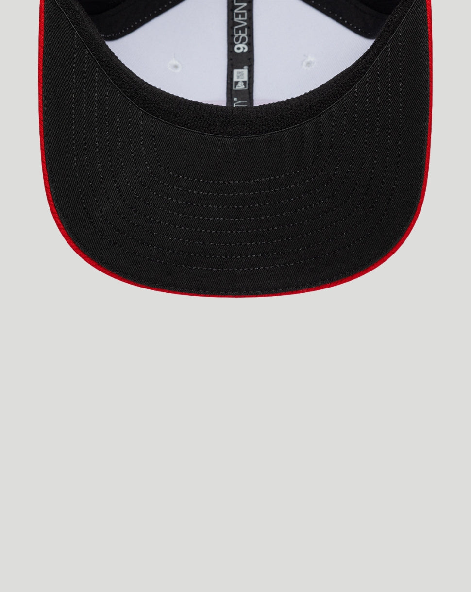 Black cap with red rim on a light gray background