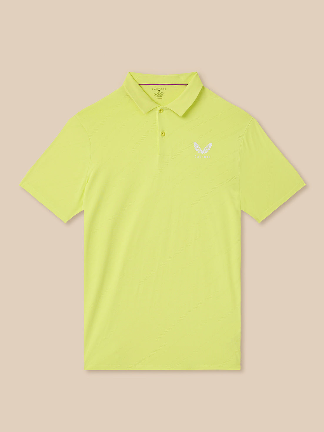 Yellow polo shirt with a logo on a beige background
