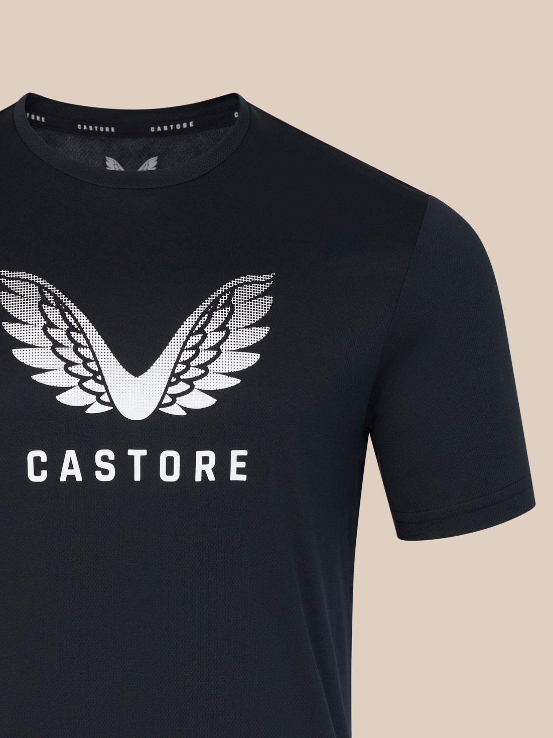 Black t-shirt with white 'Castore' logo on a beige background