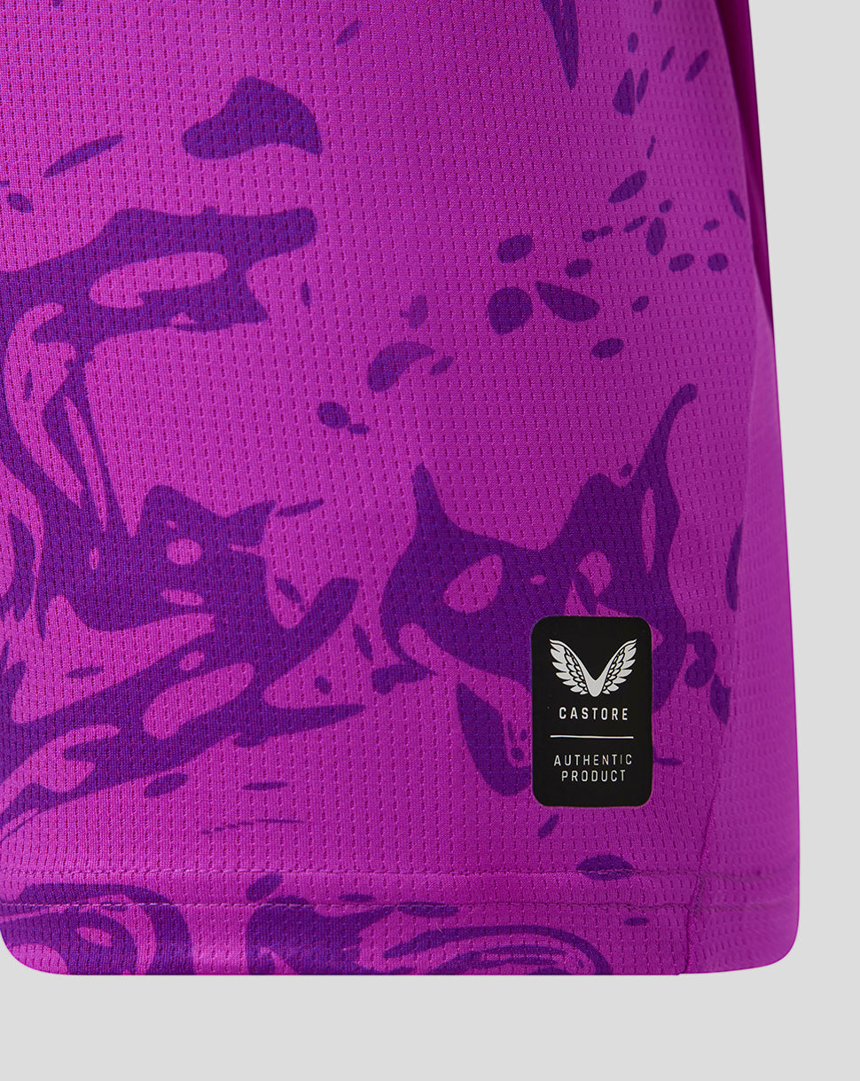 Close-up of a purple sports jersey with dark purple abstract patterns and a visible brand logo.