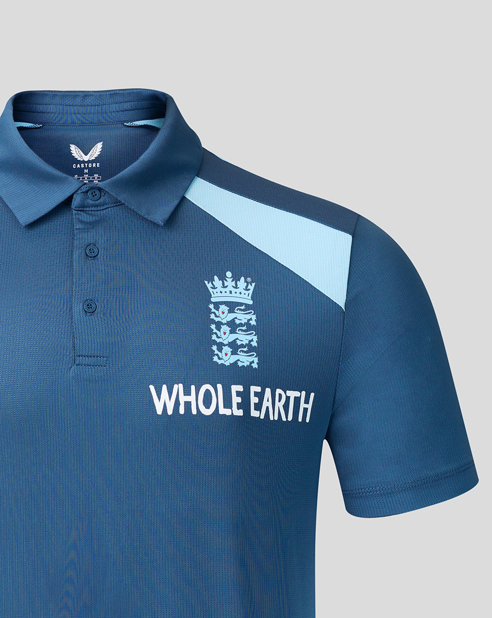 Blue polo shirt with 'Whole Earth' branding on a gray background