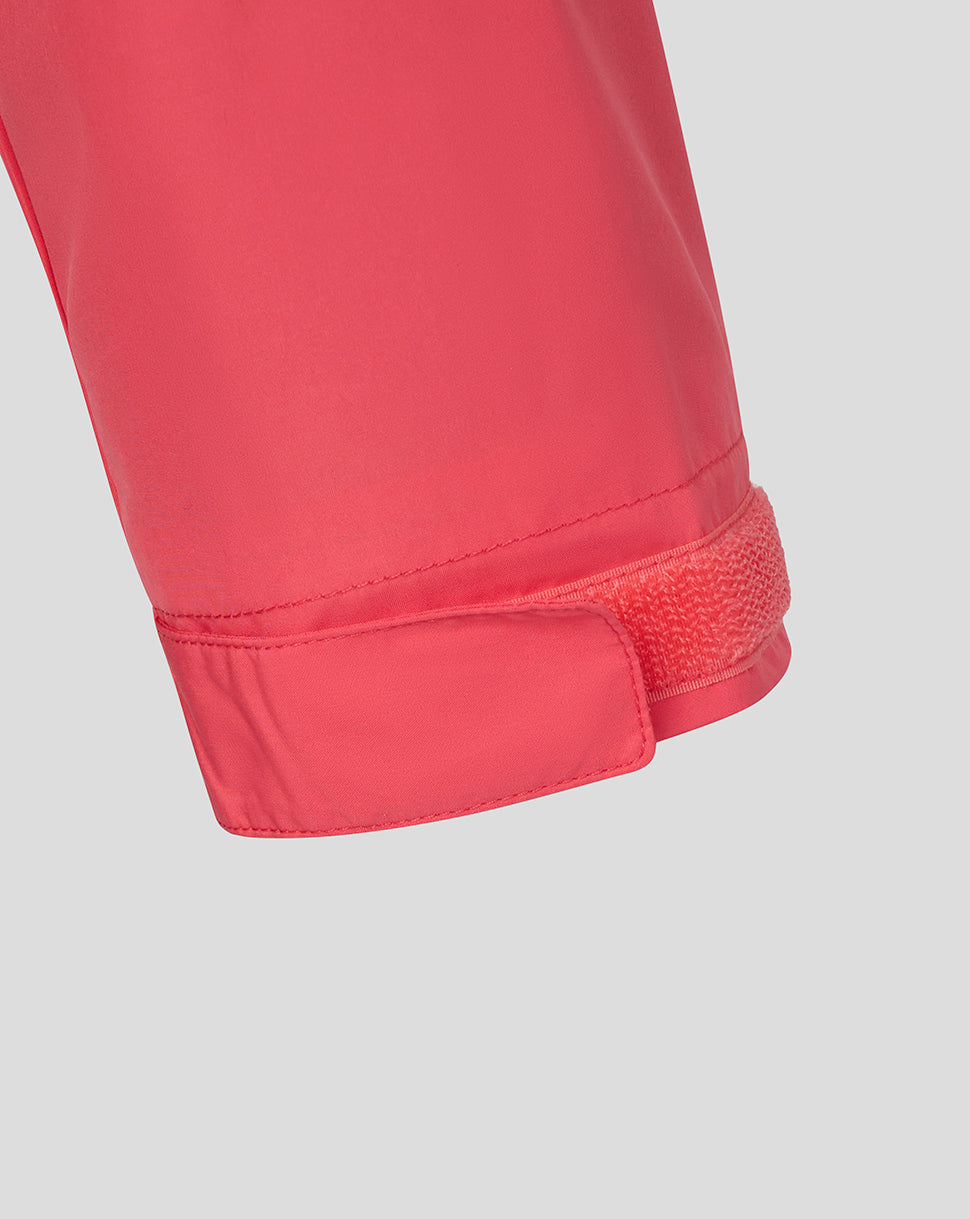 Close-up of a red jacket with velcro waistband on a light gray background