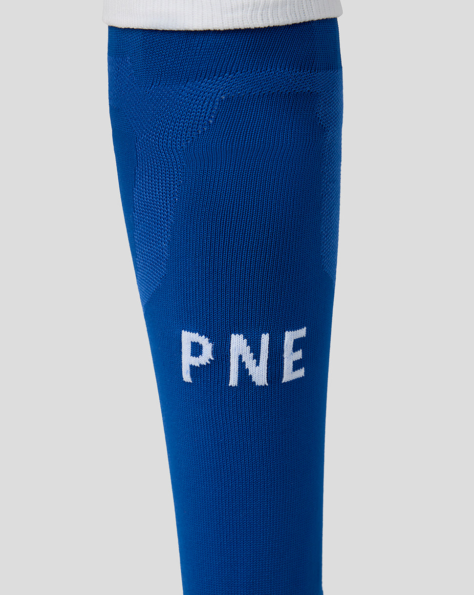 Blue knitted leggings with 'PNE' text on a light gray background