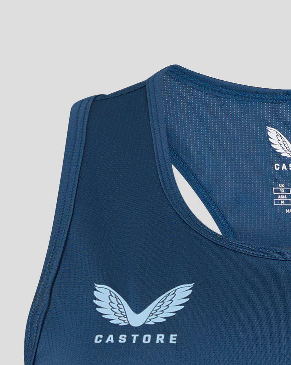 Blue athletic tank top with Castore logo on a light gray background