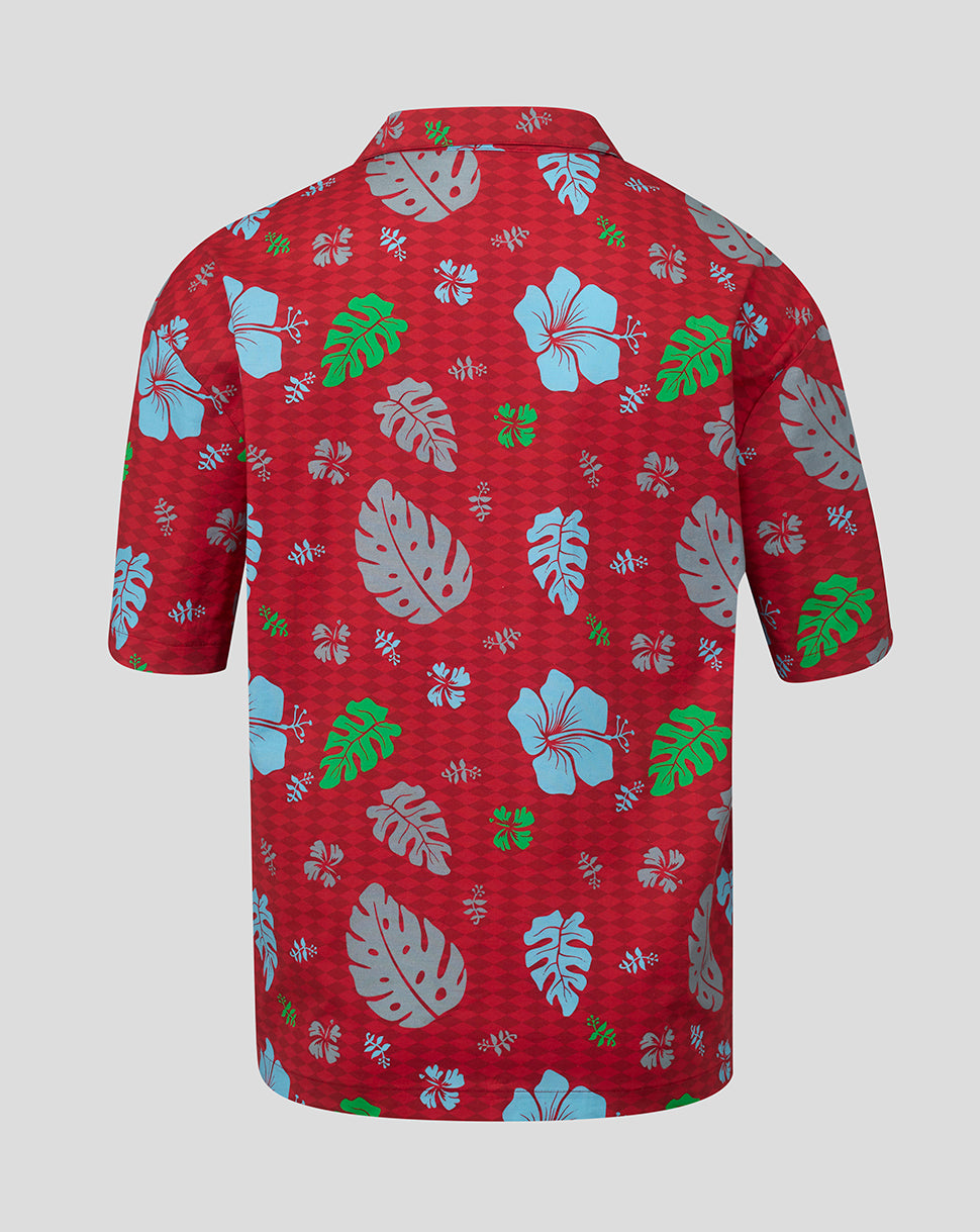 Red shirt with tropical leaf pattern on a gray background