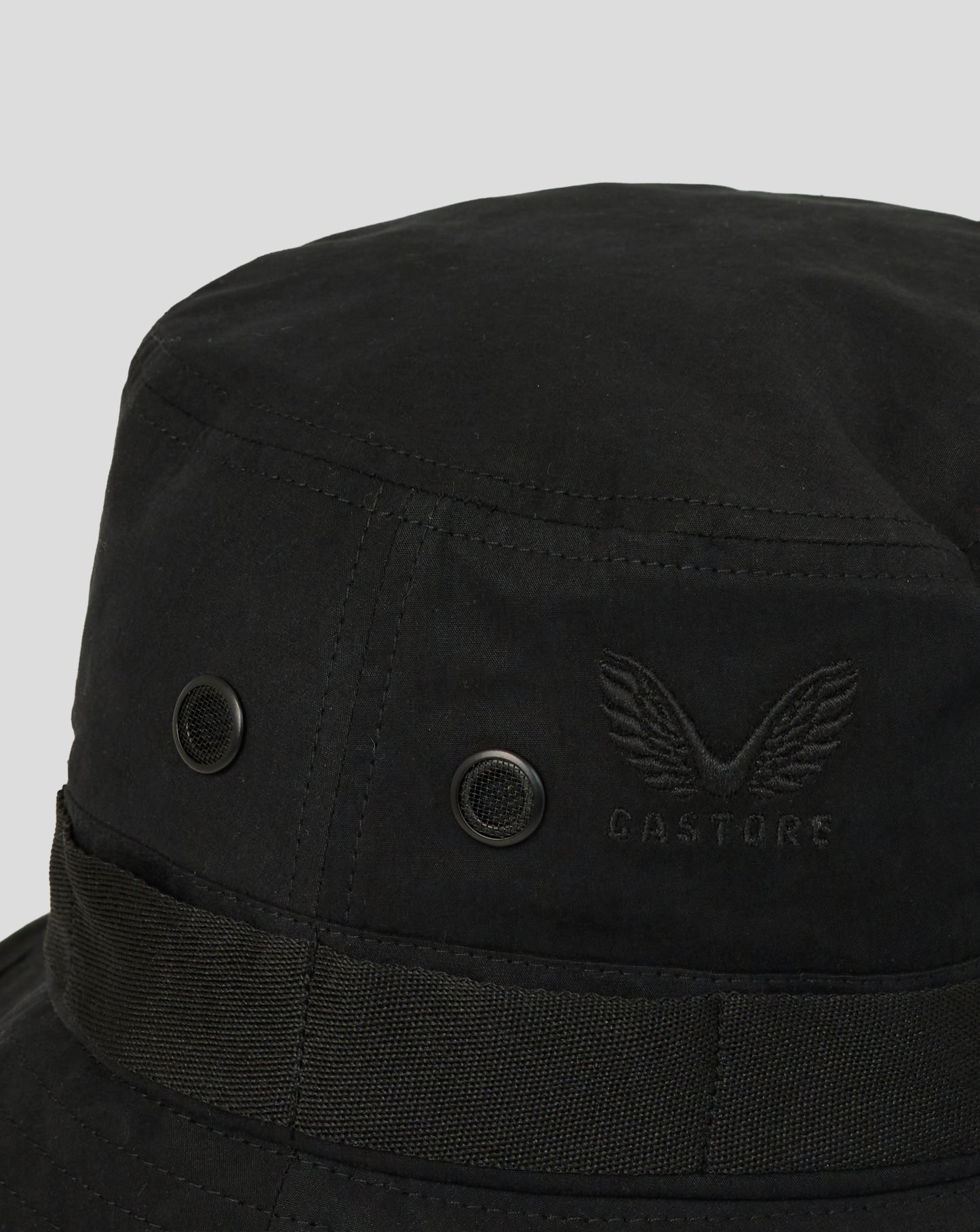 Black bucket hat with a brand logo on a light gray background