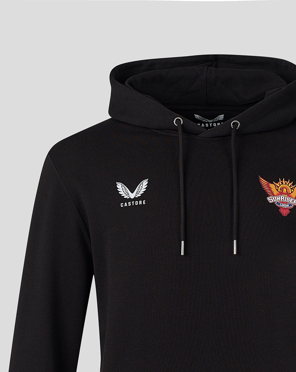 Close up of black hoodie showing Castore wing logo on left chest and colorful Sunrisers crest on right chest