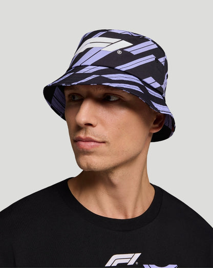 Unisex track graphic bucket hat in purple and black with bold pattern worn by model