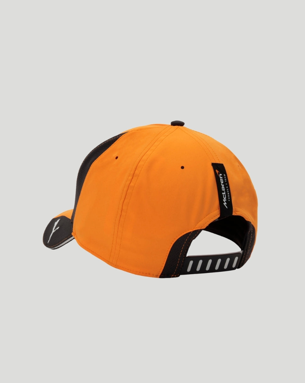 Rear angled view of the orange Papaya McLaren cap with black trim and McLaren label along the back seam.