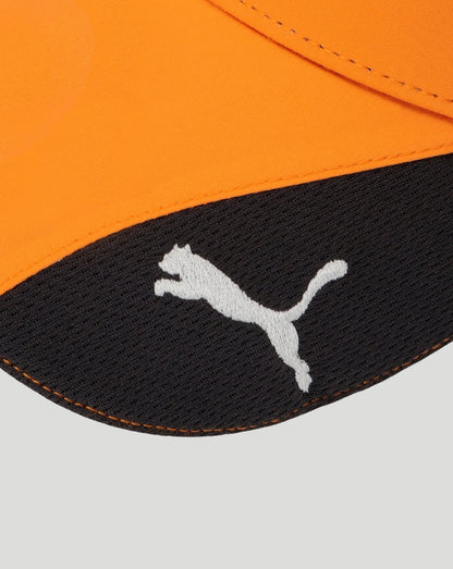 Papaya orange cap with black side panels, white Puma logo on front, Mastercard patch on the side