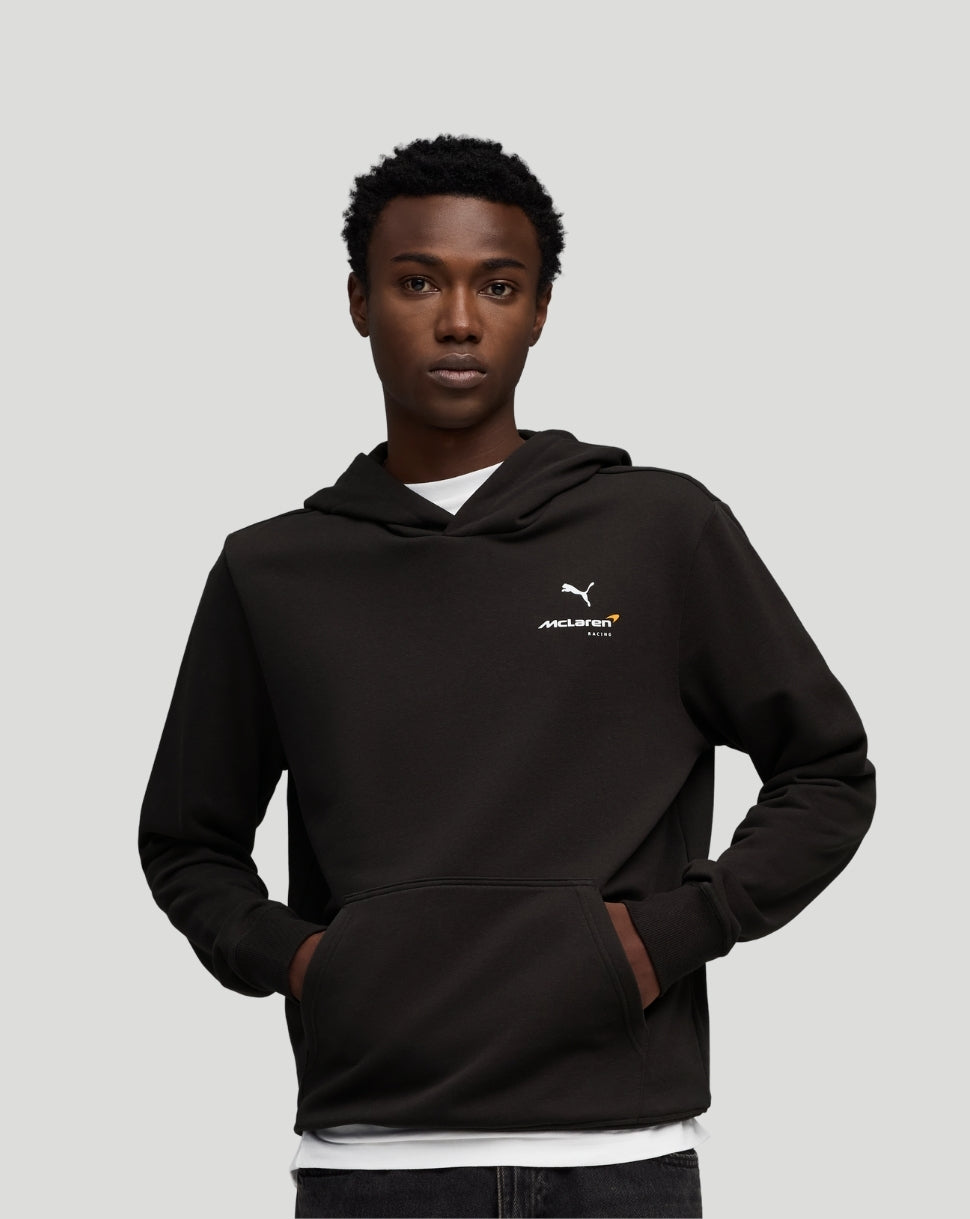 Model wearing a black McLaren Essentials hoodie with a small chest logo and a front kangaroo pocket