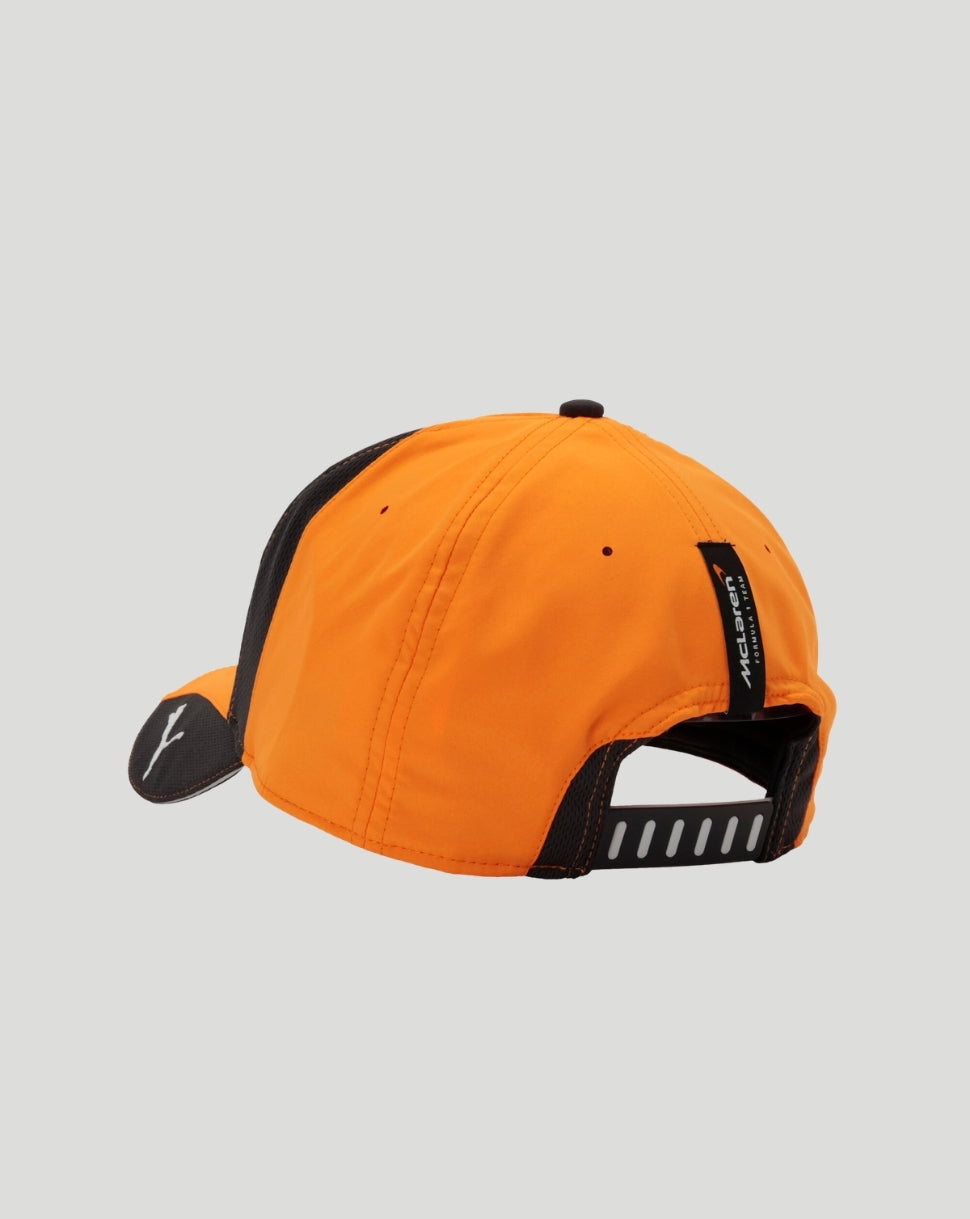 Back view of bright orange kids cap with black snapback strap and McLaren tag