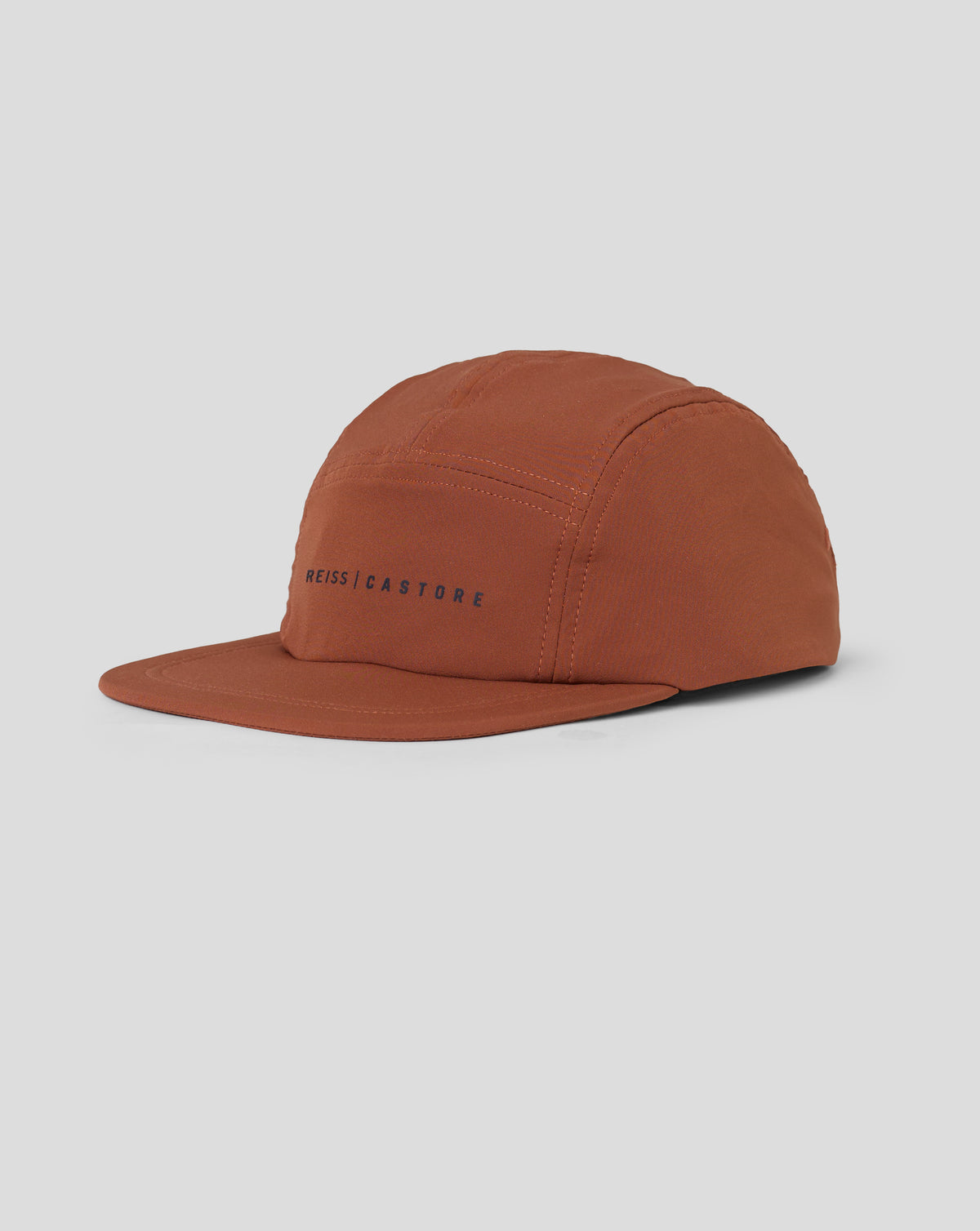 Rust colored unisex Reiss performance cap seen from the front with stitched crown panels