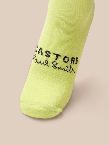 Yellow sock with branding on a beige background
