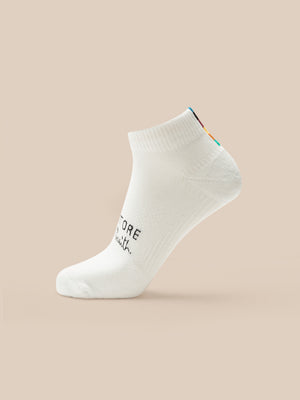 White ankle sock with text on a beige background