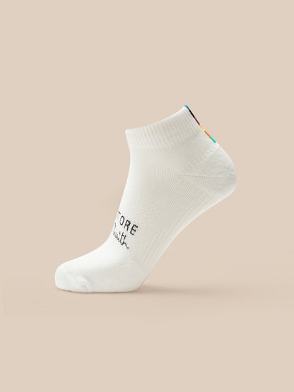 White ankle sock with text on a beige background