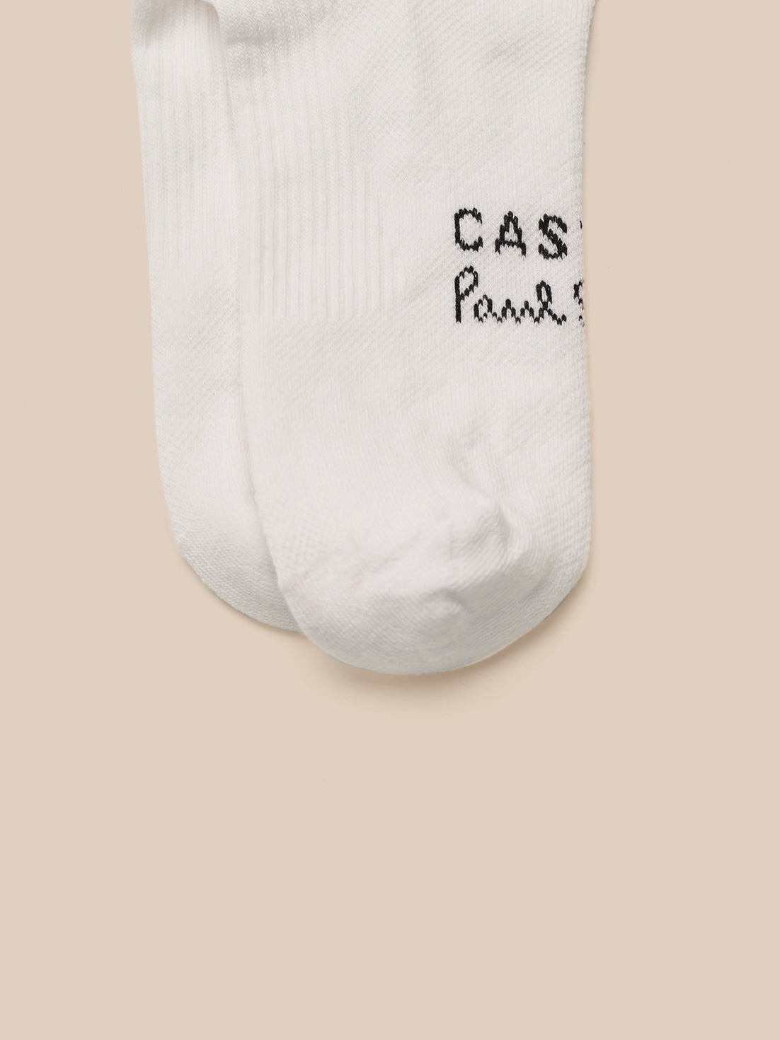 White socks with text on a beige background