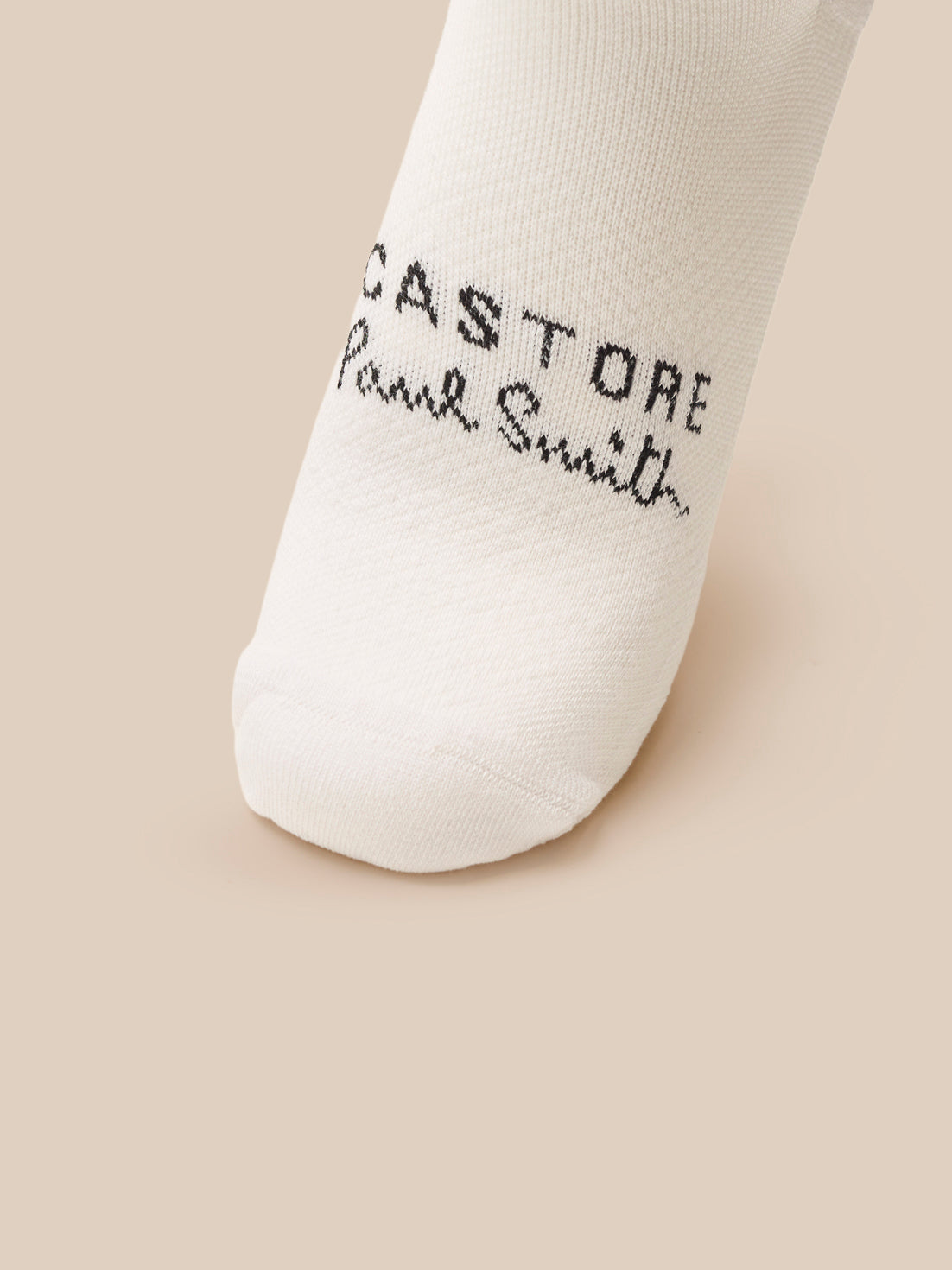 White sock with text on a beige background