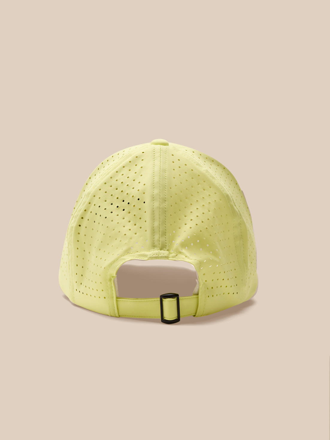 Yellow cap with a gray patch on a beige background
