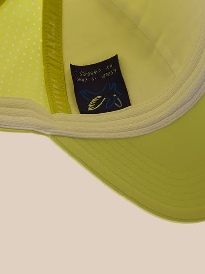Close-up of a green cap with a brand label on a beige background