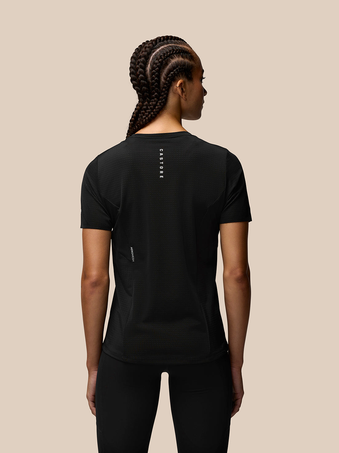 Back view of a black Apex Training T-Shirt on a model showing Castore branding down the center of the back.
