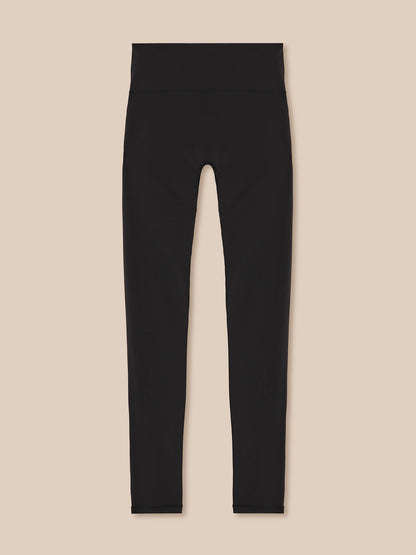 Black leggings on a beige background
