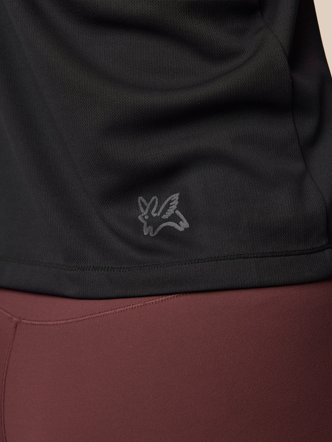 Close-up of a black and brown garment with a logo on the black section.
