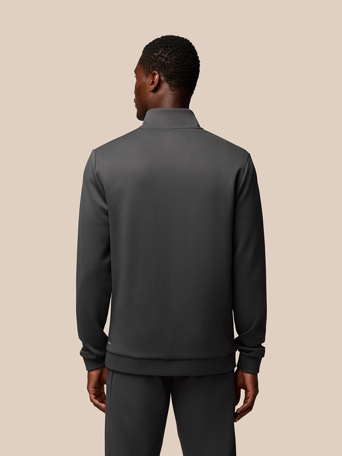 Back view of charcoal Flex Lifestyle 1/4 Zip top on model