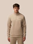 Beige Flex Lifestyle 1/4 zip top with center zip and Castore logo on left chest