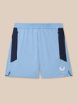 Sky blue Apex Training Shorts with navy side panels, zip pockets, and Castore logo on the leg