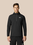 Man in black Flow Training Hoodie with half zip and white Castore logo on chest