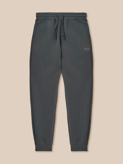 Dark gray jogger pants on a beige background