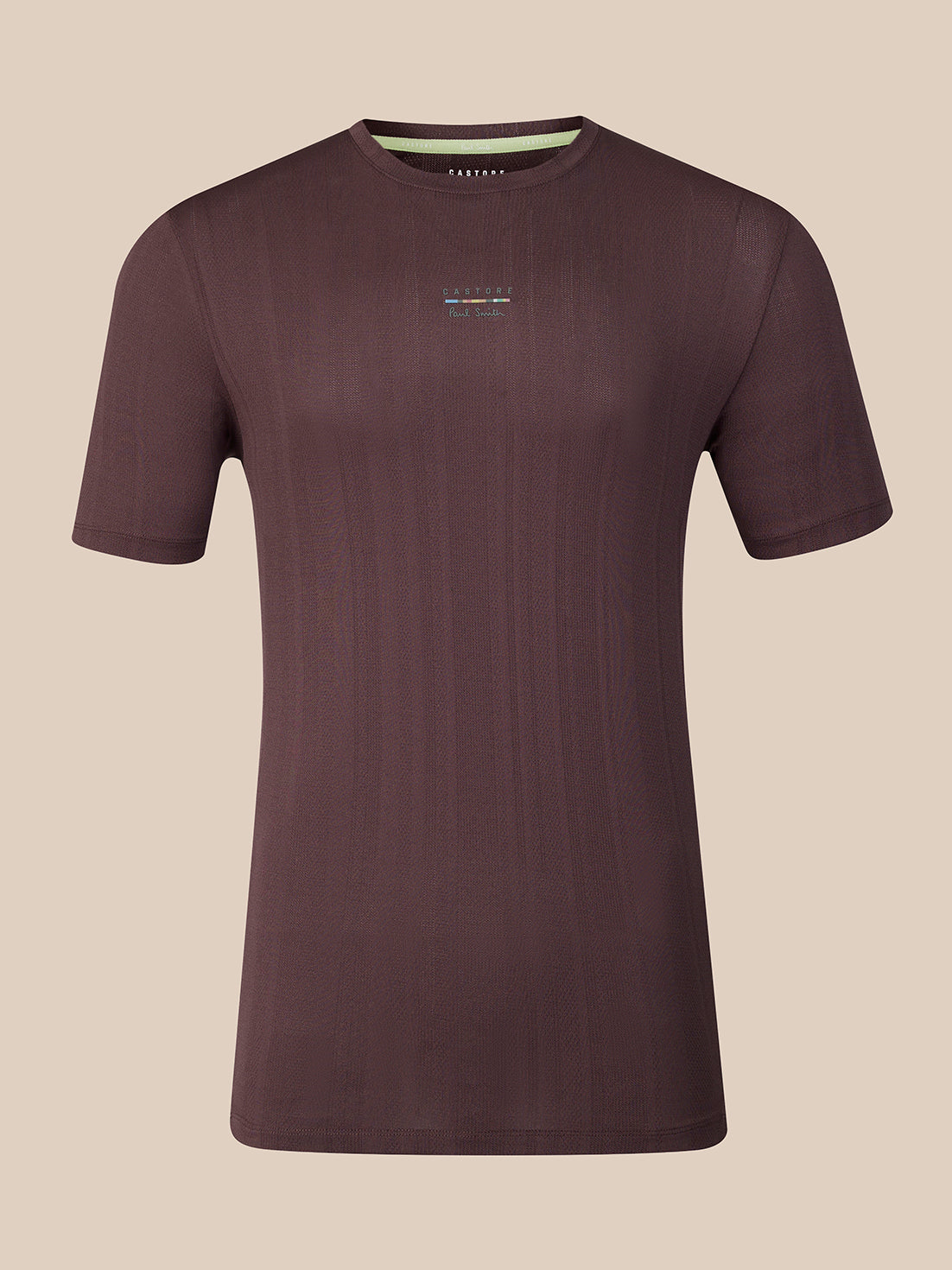 A dark brown short-sleeve athletic t-shirt with a subtle vertical ribbed texture, featuring a small multicolor logo on the center chest and a light green inner collar lining, shown against a solid beige background.