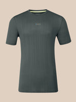 A dark gray short-sleeve crewneck t-shirt with a subtle vertical ribbed texture and a small multicolor logo on the left chest, displayed against a solid beige background.