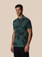 Man wearing a green camouflage polo shirt on a beige background