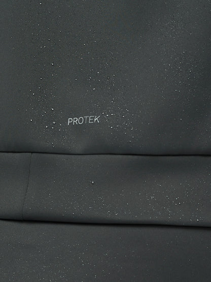 Dark gray fabric with 'PROTEK' branding on a close-up view
