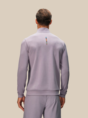 Back view of mauve long sleeve top with neck zip and a small multicolor stripe on the upper back.