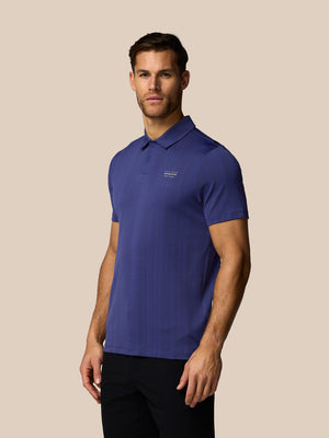 Man wearing a blue polo shirt on a beige background
