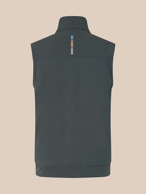 A dark gray sleeveless vest shown from the back, featuring a high collar and a small vertical multicolor logo detail on the upper back, set against a solid beige background.