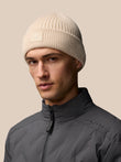 Stone colored ribbed knit Active Beanie with foldover Castore logo patch worn by a model.