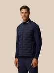 Male model wearing Golf Pinnacle Jacket in midnight navy with quilted front panel and stand collar