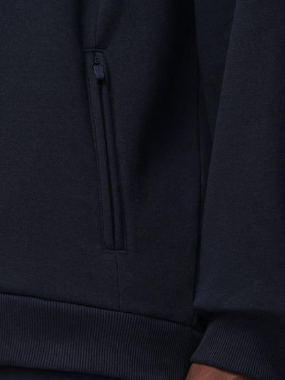 Close-up of a dark blue hoodie with a zipper detail.