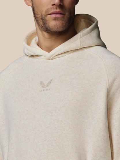 Beige hoodie with a brand logo on a beige background