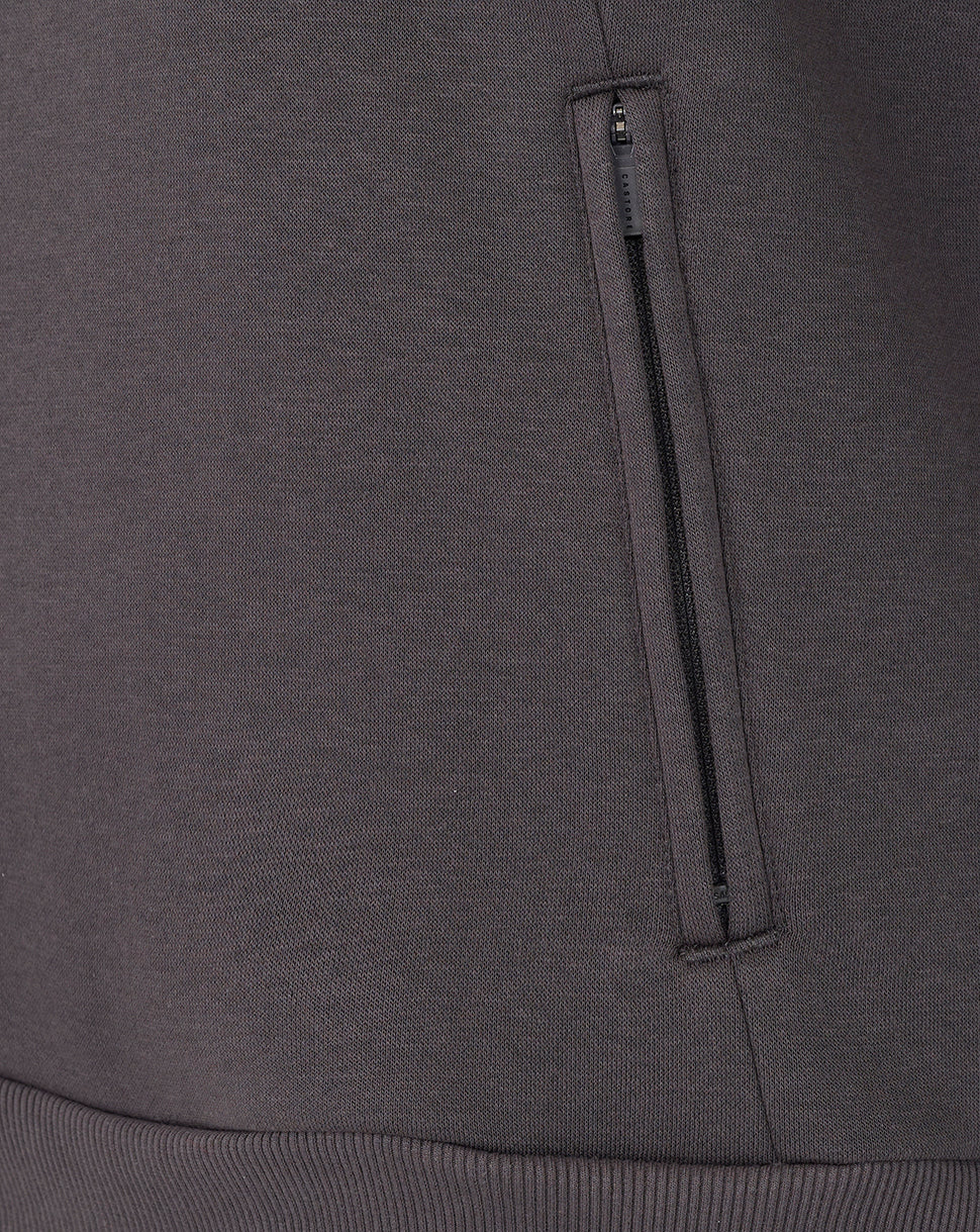 Close-up of a dark gray sweatshirt with a zipper pocket.