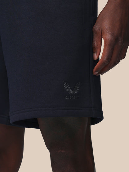 Navy blue shorts with a logo on a beige background