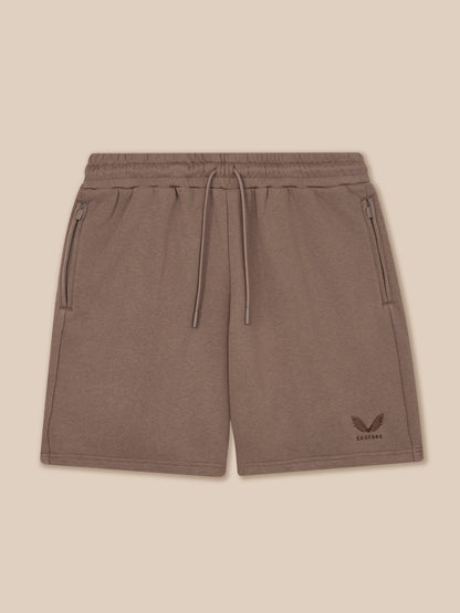 Brown shorts with a logo on a beige background