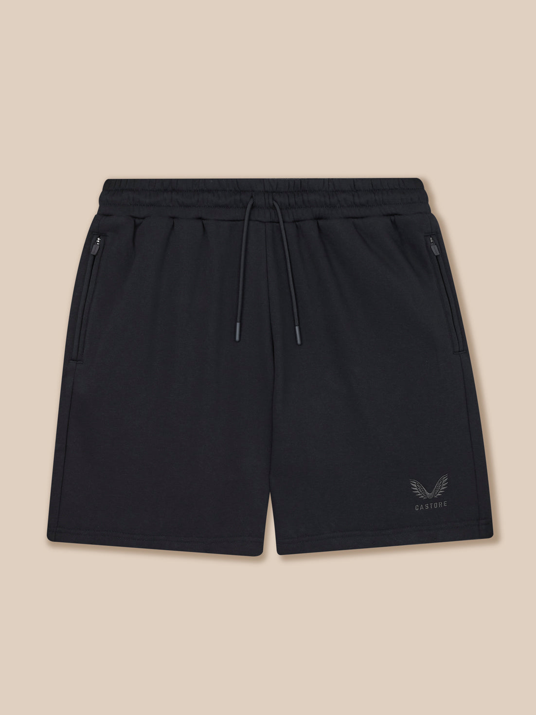 Black shorts with a brand logo on a beige background