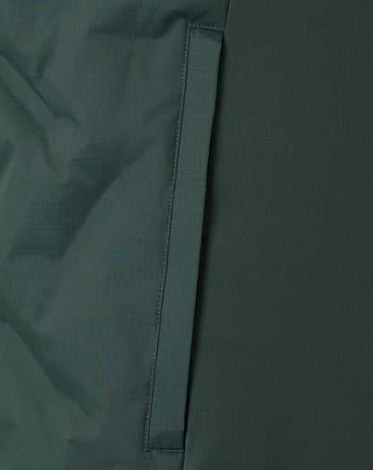 Close-up of a dark green fabric with a visible seam