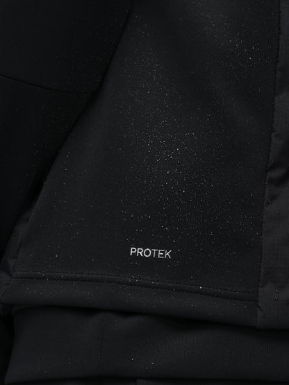Close-up of a black jacket with 'PROTEK' branding on a dark background
