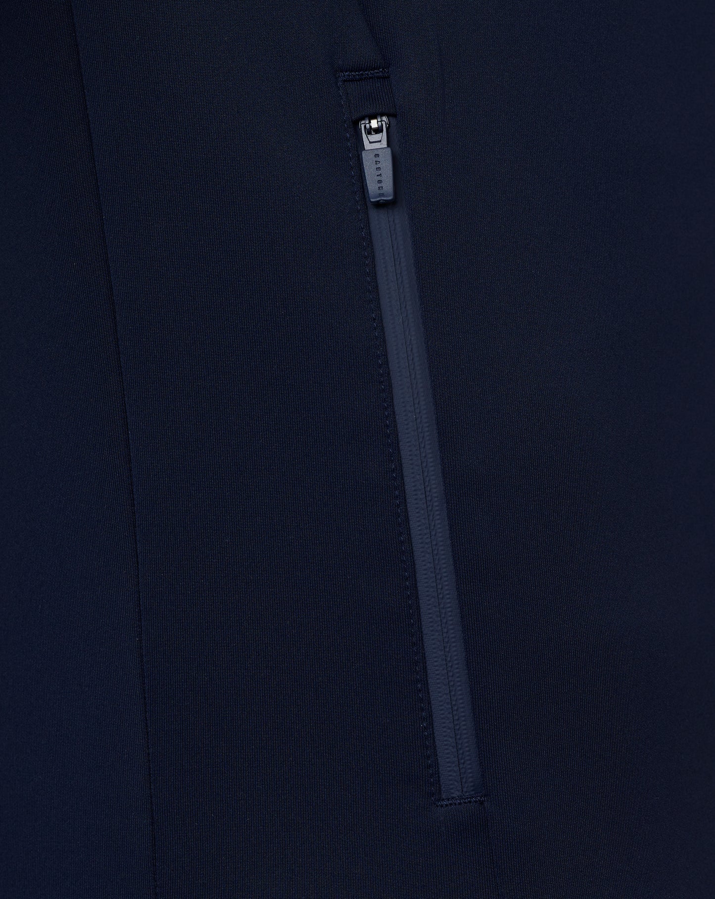 Close-up of a navy blue zipper on a dark background